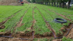 Effluent field lines being laid for wastewater dispersal at a property