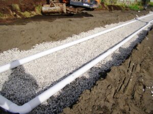 Soak bed being installed for wastewater drainage at a property