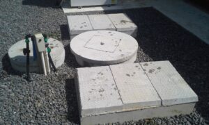 Aerogreen wastewater treatment system installed in a landscaped stone garden
