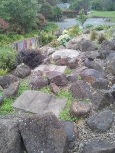 Septech 2000 wastewater treatment unit integrated into landscaped garden with rocks