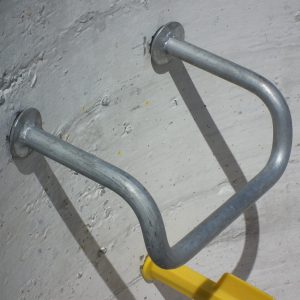 Galvanised steel manhole step with slip-resistant tread for concrete installation.