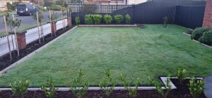Concrete garden edging installed along a flower bed, showing clean and durable border